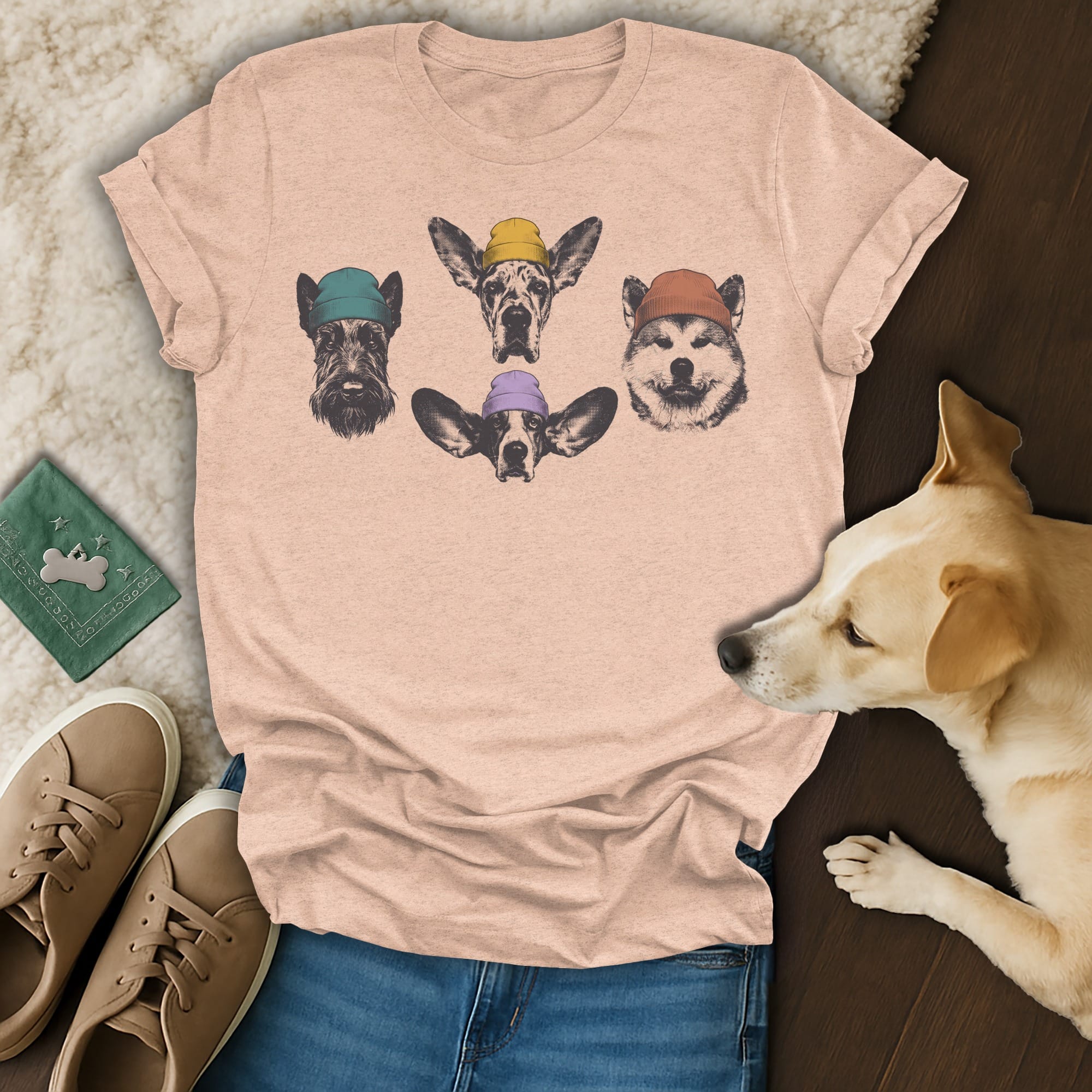 T-shirt with four dog heads wearing colorful beanies.