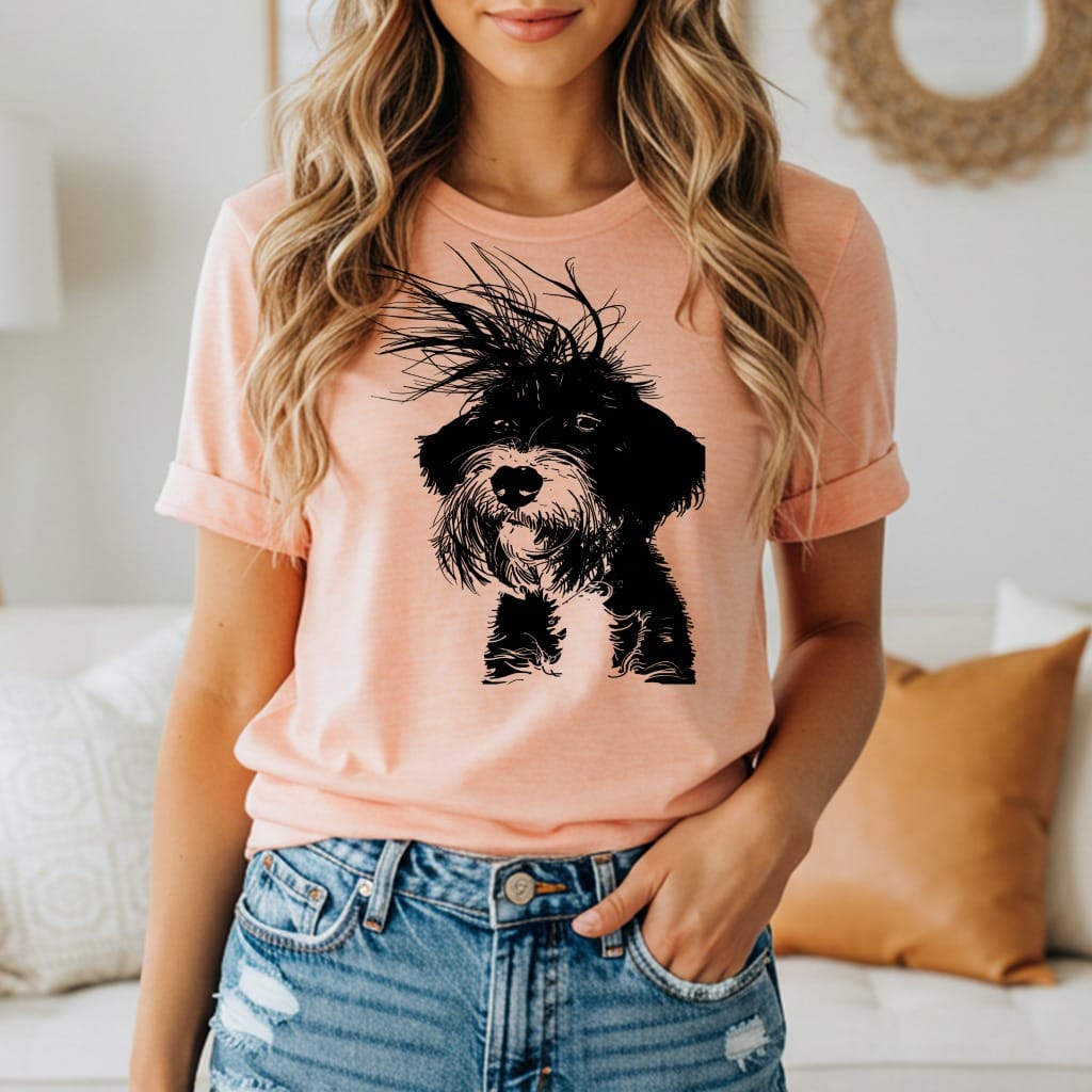 Black and white scruffy dog graphic on a light peach t-shirt.