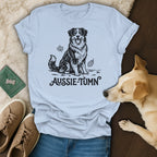 Light blue t-shirt with black ink sketch of a sitting Aussie dog and "Aussie-Tumn" text.