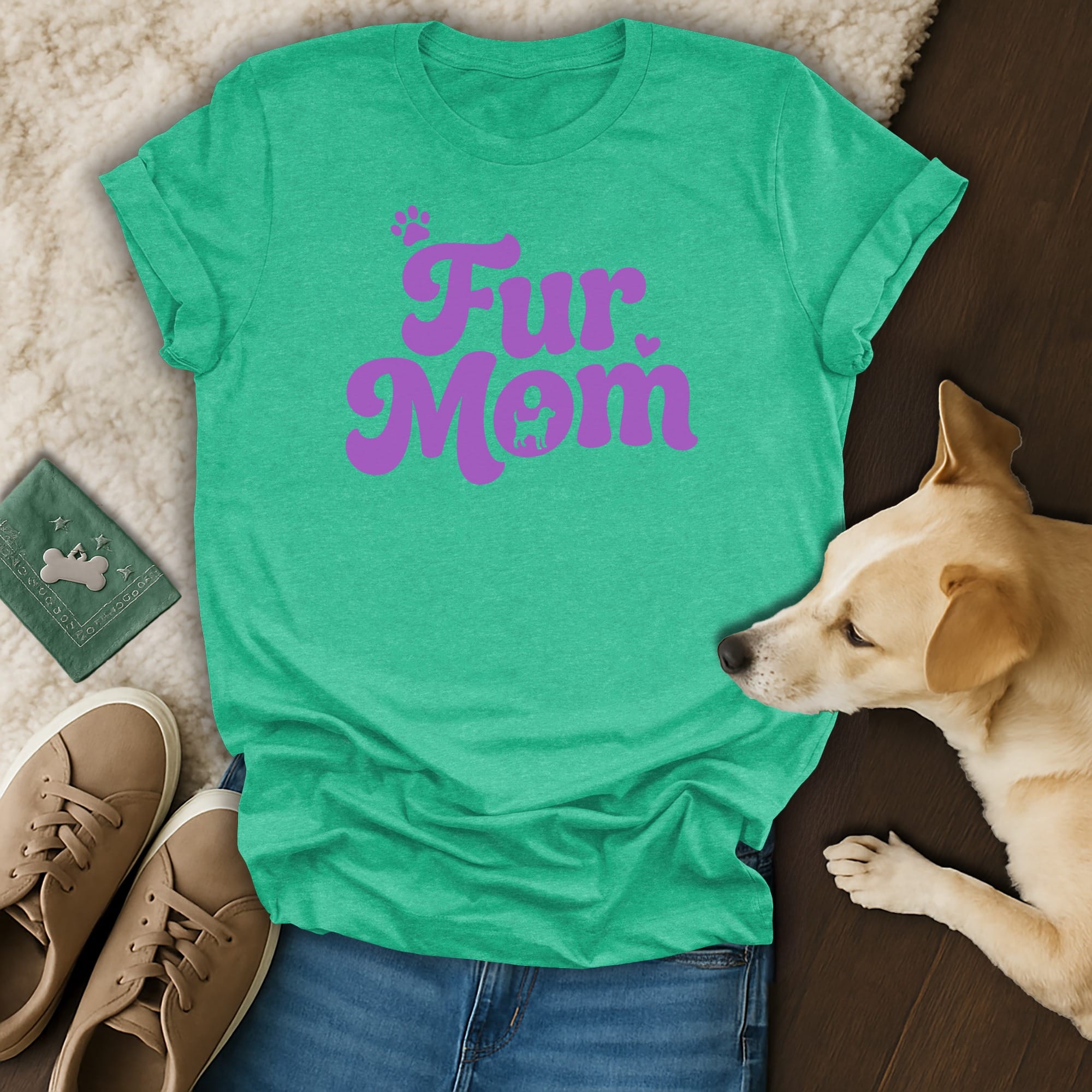 Teal t-shirt with "Fur Mom" text in purple, next to jeans and a dog.