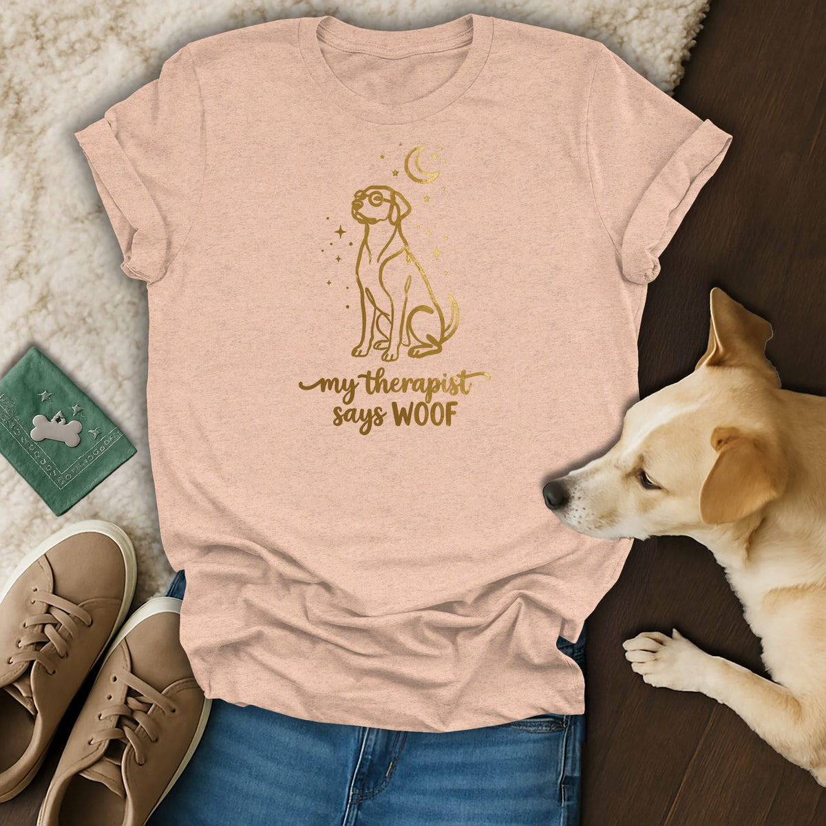 Peach t-shirt with gold outline of a dog, moon, and stars, reading "my therapist says WOOF".