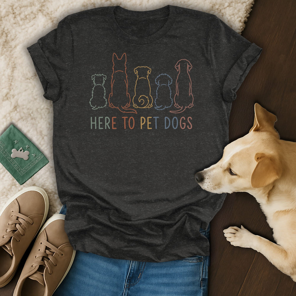 Dark t-shirt with colorful dog outlines and "HERE TO PET DOGS" text.