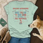 Light sage green t-shirt with text "She talks to her dog in full sentences".