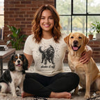 Woman sitting with Cavalier King Charles Spaniel and Labrador Retriever, wearing shirt that says "shake it off".