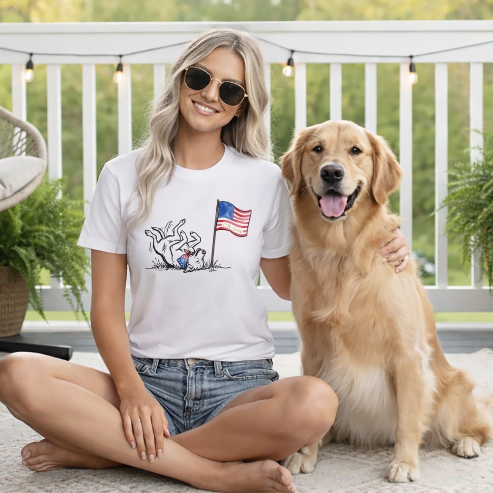 Woman and golden retriever with American flag design on t-shirt.