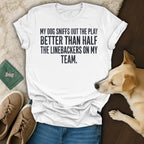 White t-shirt with text: "My dog sniffs out the play better than half the linebackers on my team."