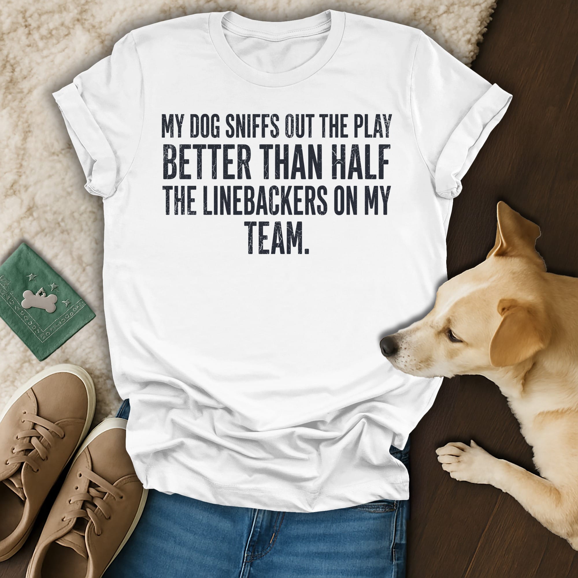 White t-shirt with text: "My dog sniffs out the play better than half the linebackers on my team."