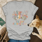 Grey t-shirt with a colorful dog and "WILD FLOWER CHILD" text.
