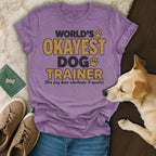 Purple t-shirt with "World's Okayest Dog Trainer" text and a dog.
