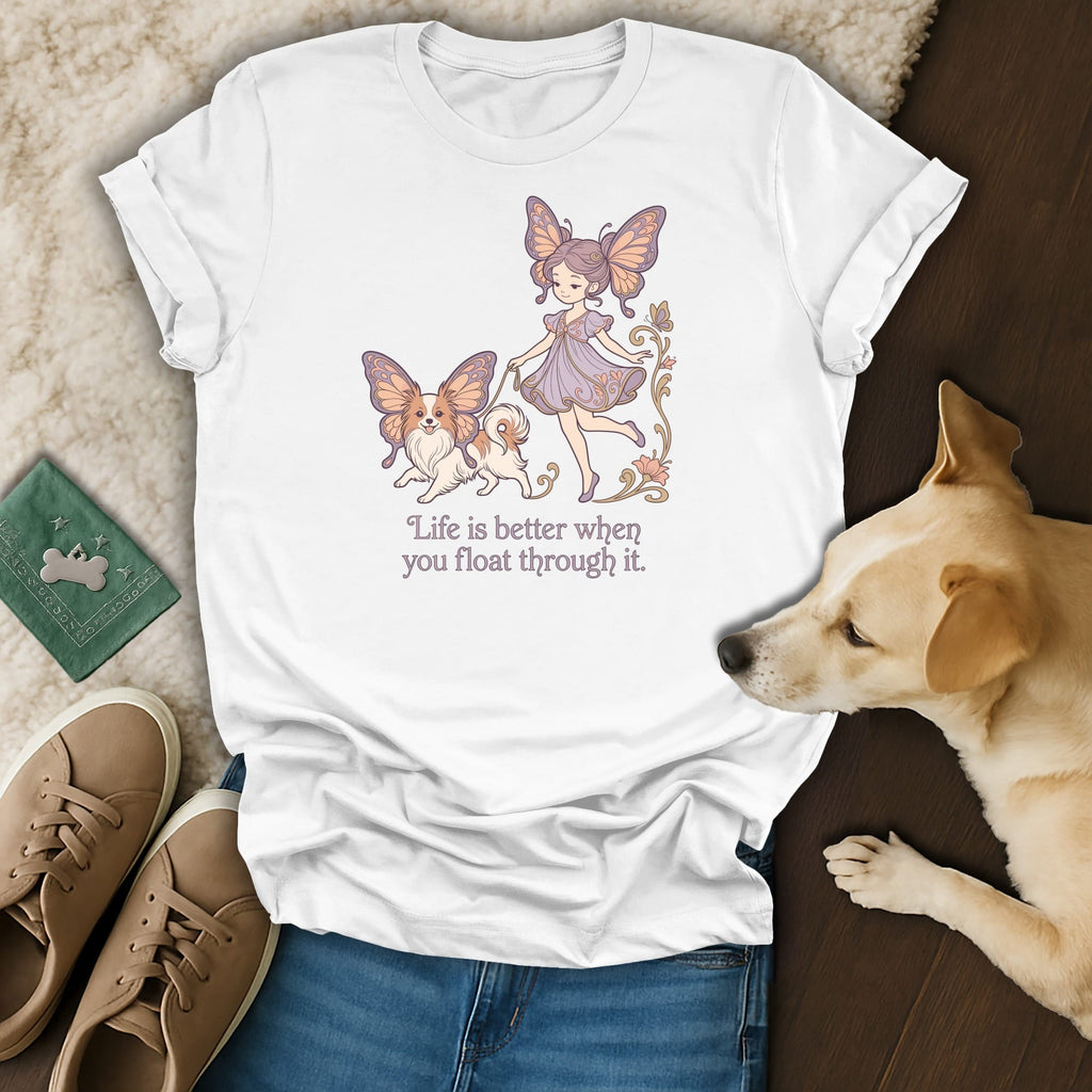 White t-shirt with butterfly girl and dog illustration and text "Life is better when you float through it."