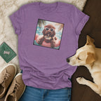 Purple t-shirt featuring a brown dog wearing sunglasses and a hat, floating on a pink flamingo.