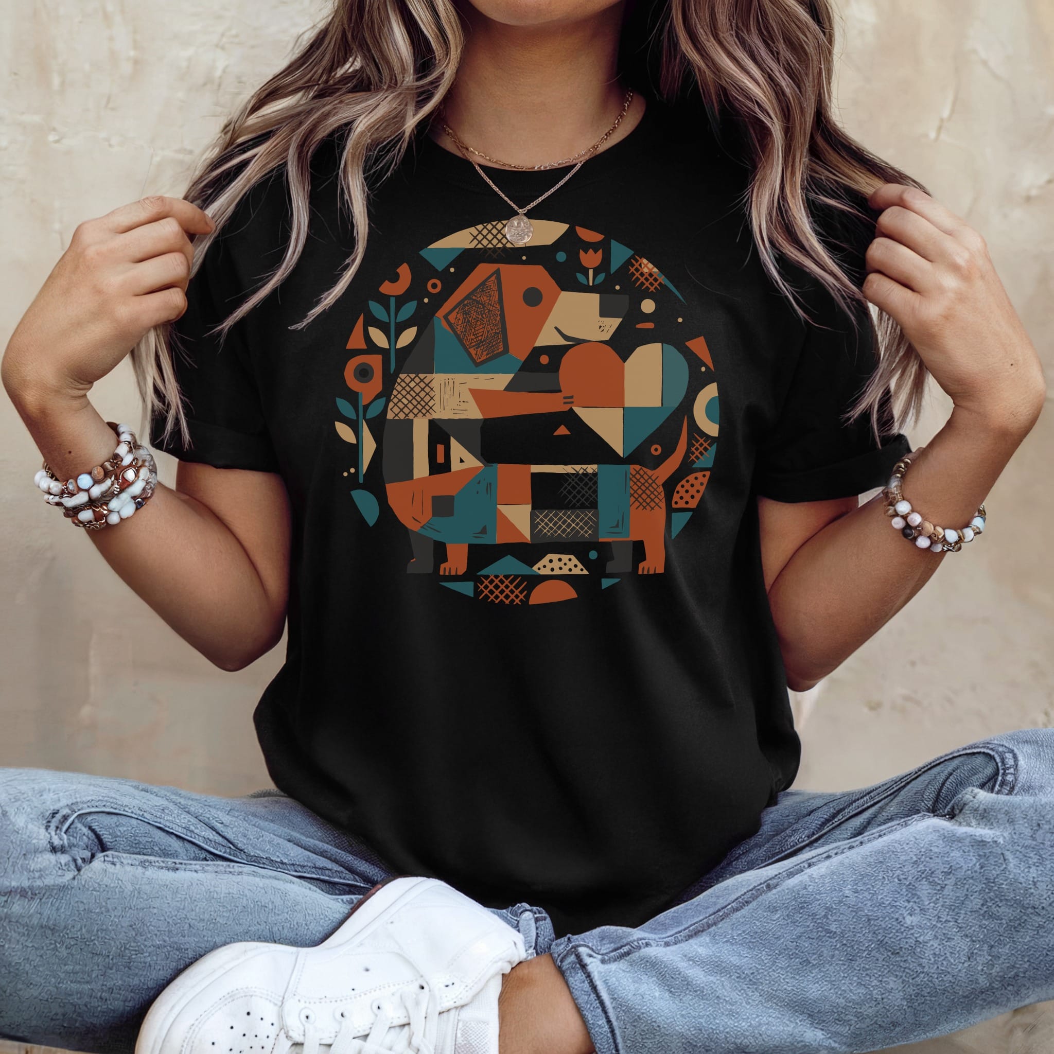 Black t-shirt featuring a geometric dachshund graphic with colorful shapes.