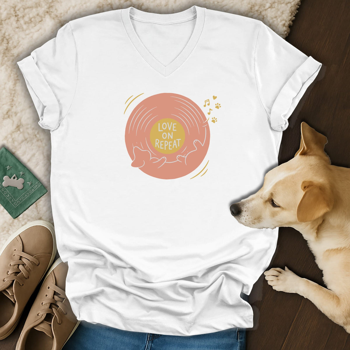 White V-neck t-shirt featuring a pink record graphic with the text Love on Repeat.