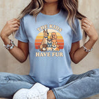 Light blue t-shirt with cartoon dogs and text "The Kids Have Fur."