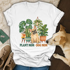 A white v-neck t-shirt featuring a graphic of a French bulldog surrounded by houseplants and the text Plant Mom Dog Mom.