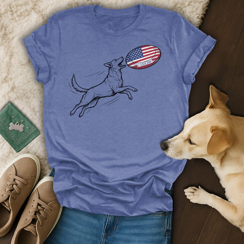 Dog jumping to catch American flag rugby ball on blue t-shirt.