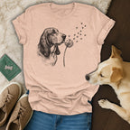 Basset hound blowing dandelion seeds with paw prints.