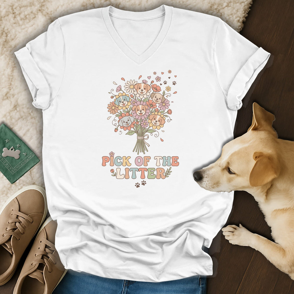 White v-neck t-shirt with cartoon puppies and flowers graphic, saying "Pick of the Litter".