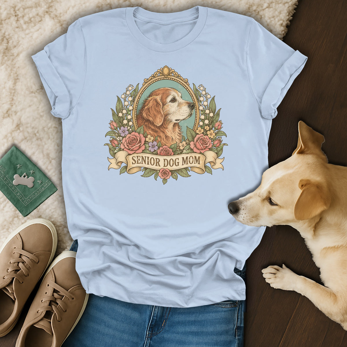 A light blue t-shirt with a "Senior Dog Mom" graphic featuring a golden retriever in a floral frame.