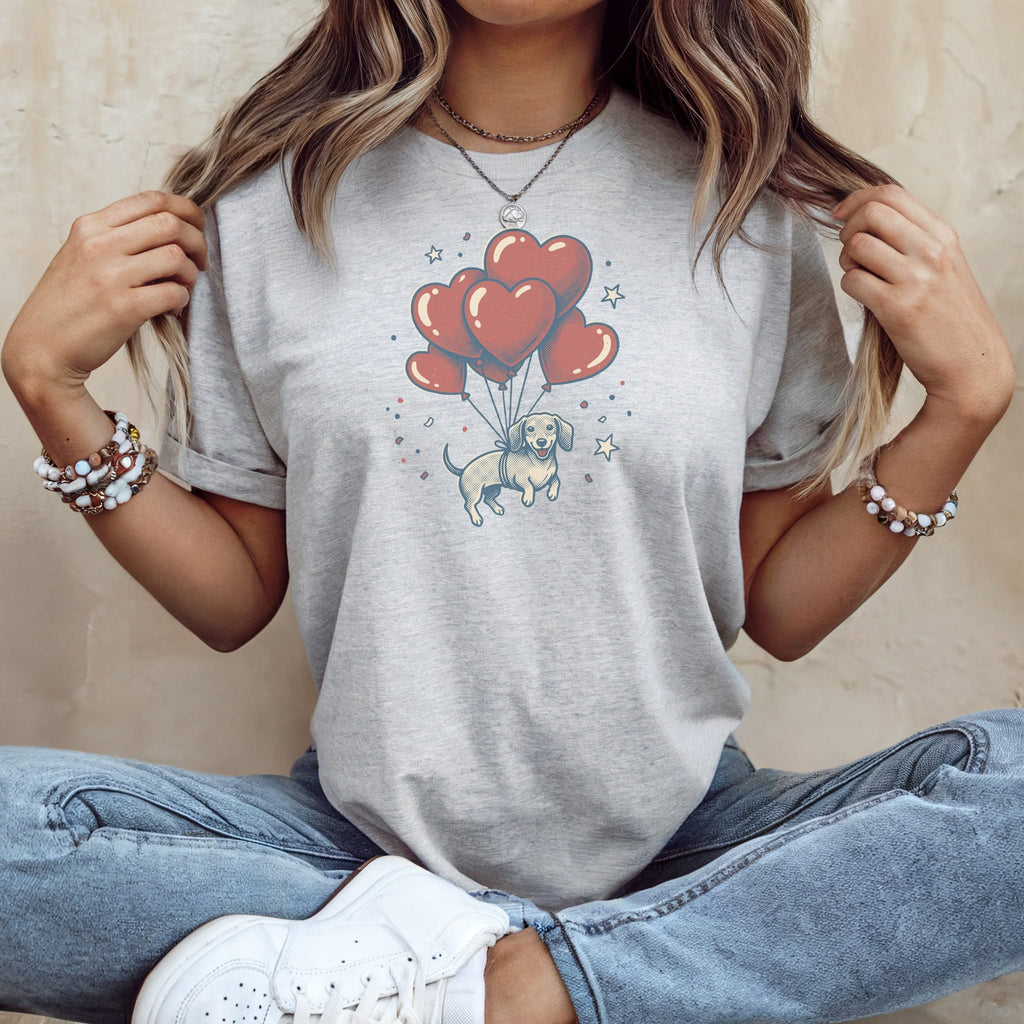 Dachshund dog graphic on a light grey t-shirt, floating with heart balloons.