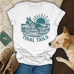 White t-shirt with graphic of dog surfing on waves, sun in background.