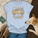 Light blue t-shirt with four dogs in a wagon and text "HAY THERE AUTUMN".