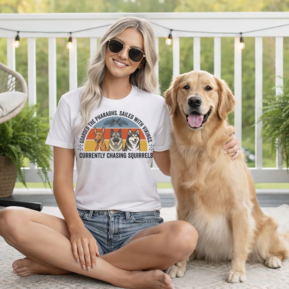 Woman with golden retriever wearing t-shirt with dogs and text.