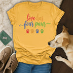 Yellow t-shirt with "love has four paws" and colorful paw prints.
