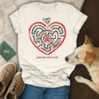 White t-shirt with heart maze, red paw prints, and "Every Paw Leads to Love" text.