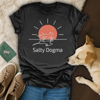 Black t-shirt with "Salty Dogma" logo, featuring a sun and running dogs.