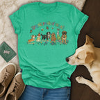 Green t-shirt with cartoon dogs and spring floral design.