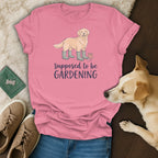 Pink t-shirt with golden retriever, gardening boots, and text "supposed to be GARDENING".