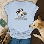 Light blue t-shirt with a cartoon dog digging in dirt and text "CURRENTLY BETWEEN PROJECTS."