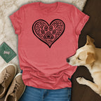 Pink t-shirt with a black heart graphic filled with paw prints and smaller hearts.