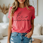 Red t-shirt with "we the people and our dogs" text and feather, heart, paw prints.