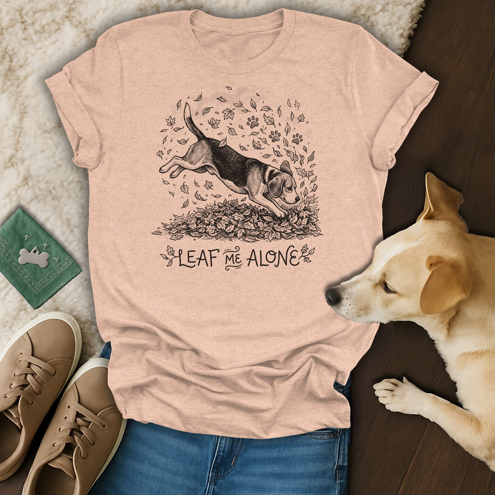 Peach t-shirt with beagle jumping in leaves graphic and "Leaf Me Alone" text.