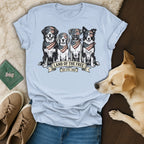Light blue t-shirt with four dogs wearing bandanas and sunglasses, text "Land of the Free."