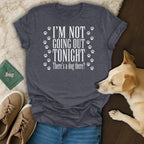 Charcoal t-shirt with white text "I'm Not Going Out Tonight, There's a dog there?" and paw prints.