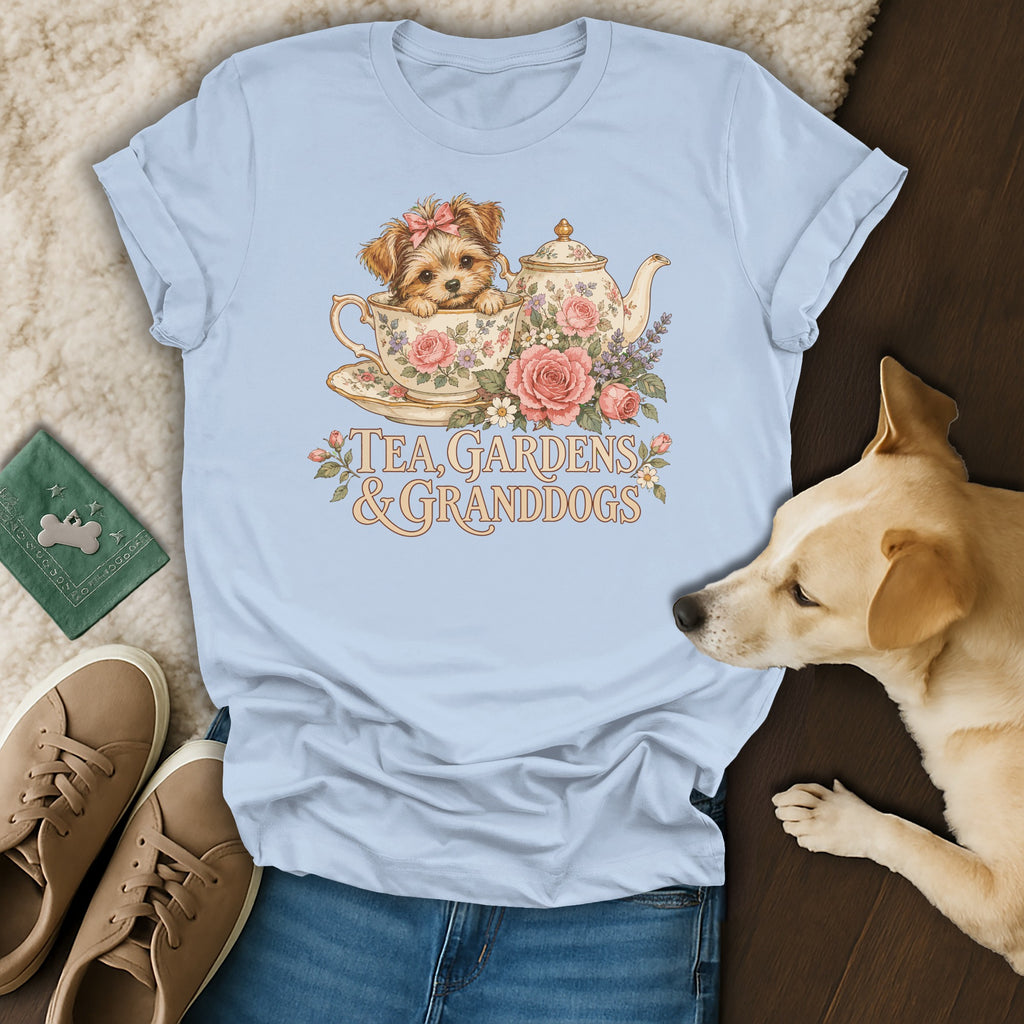 Light blue t-shirt featuring a vintage illustration of a puppy in a teacup with floral elements and text.