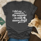 Dark grey v-neck t-shirt with white text "I did my research the answer is still more dogs".