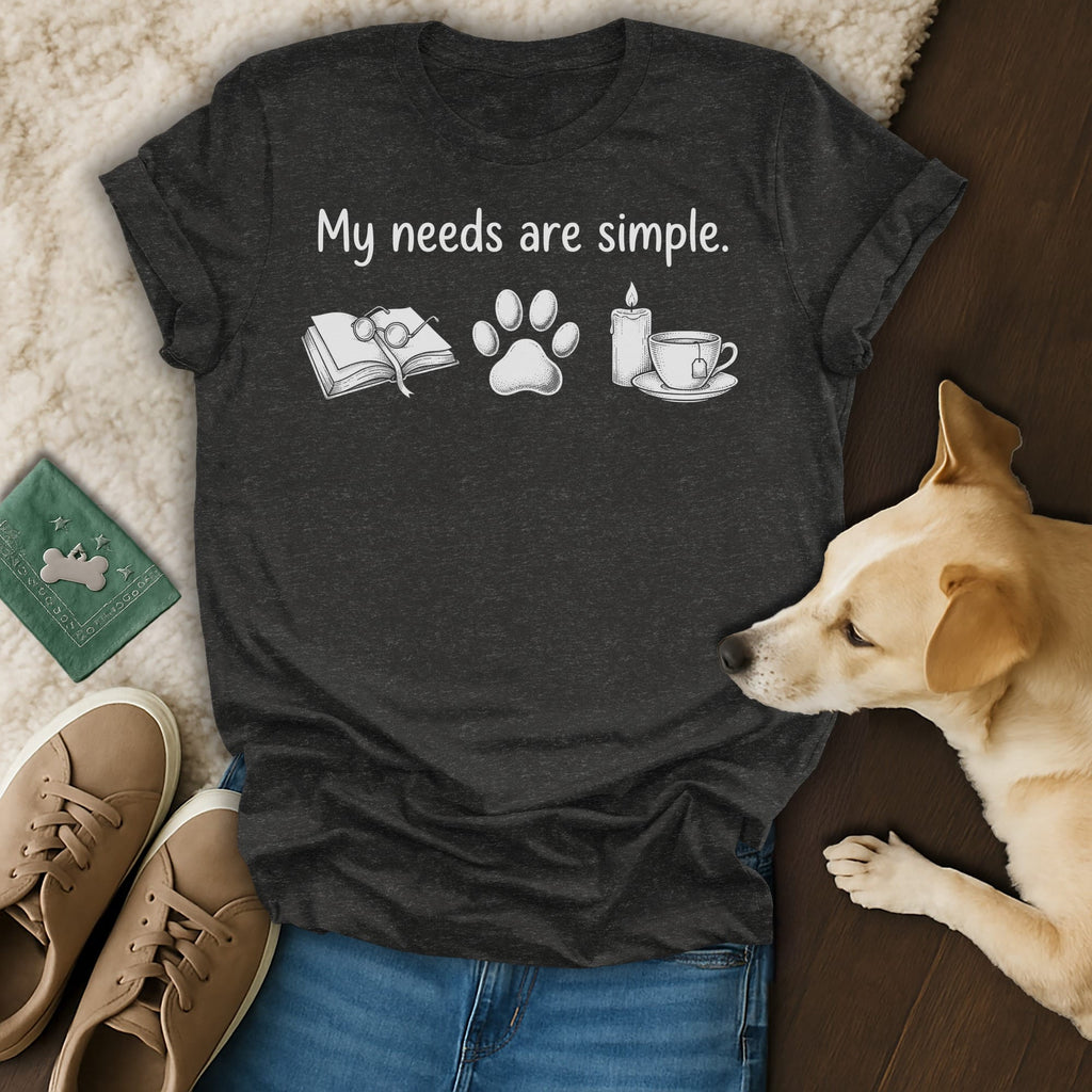 Dark gray t-shirt with text "My needs are simple" and icons of book, paw print, candle, and tea.