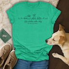 Green t-shirt with dog line art and text: "Life is better with a dog OR TWO, OR THREE..."