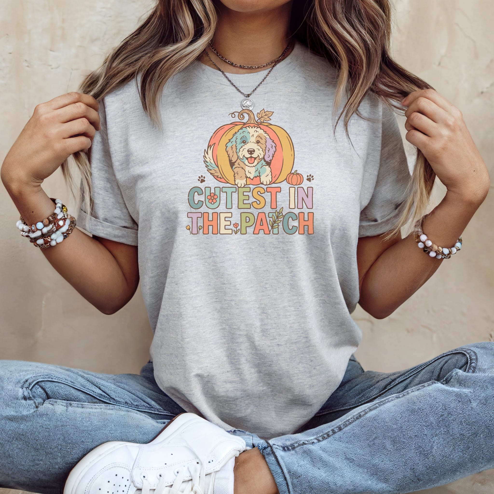 Grey t-shirt with colorful dog inside pumpkin graphic that reads "Cutest in the Patch".