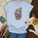 Light blue t-shirt with a graphic of a brown dog wearing a green knitted hat.
