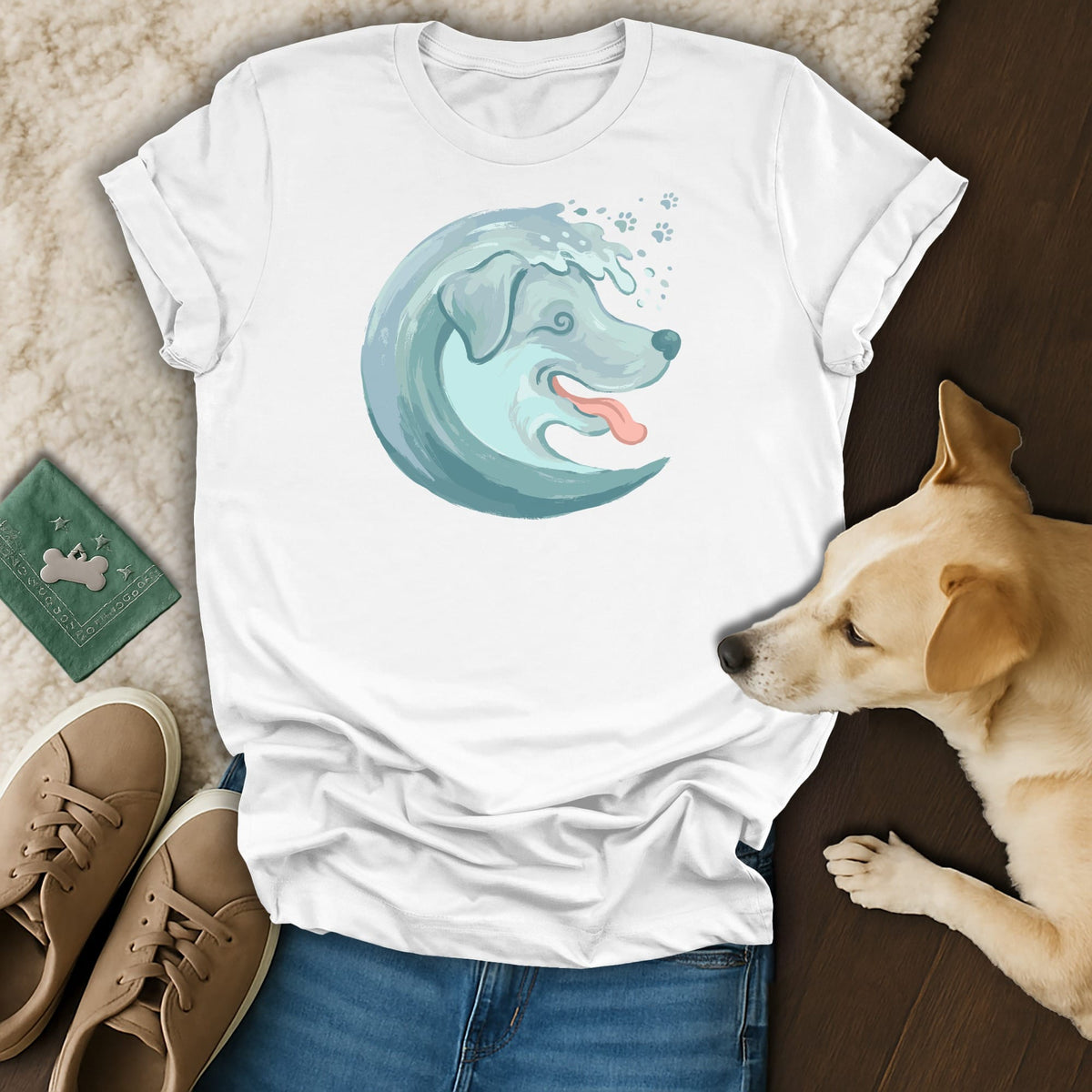 White t-shirt with a blue watercolor dog and wave graphic and paw prints.