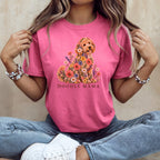 A person wearing a pink t-shirt with a floral doodle graphic and the text "DOODLE MAMA".