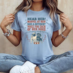 Light blue t-shirt with "Hear Her! Marvel At Her! Does a Different Voice For Each Of Her Dogs and Answers Herself Back" text and two dogs.