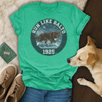 Green t-shirt with "Run Like Balto 1925" text and a dog illustration.