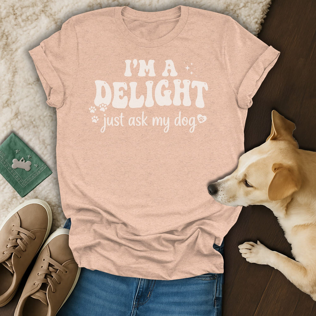 Peach t-shirt with "I'm a delight just ask my dog" text and paw prints.