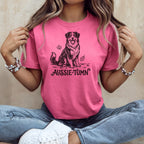 Australian Shepherd dog illustration with "Aussie-Tumn" text on a pink t-shirt.